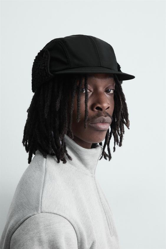 TECHNICAL CAP WITH SHEARLING EAR FLAPS