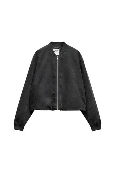 Front view of a black jacket with a zipper and side pockets.