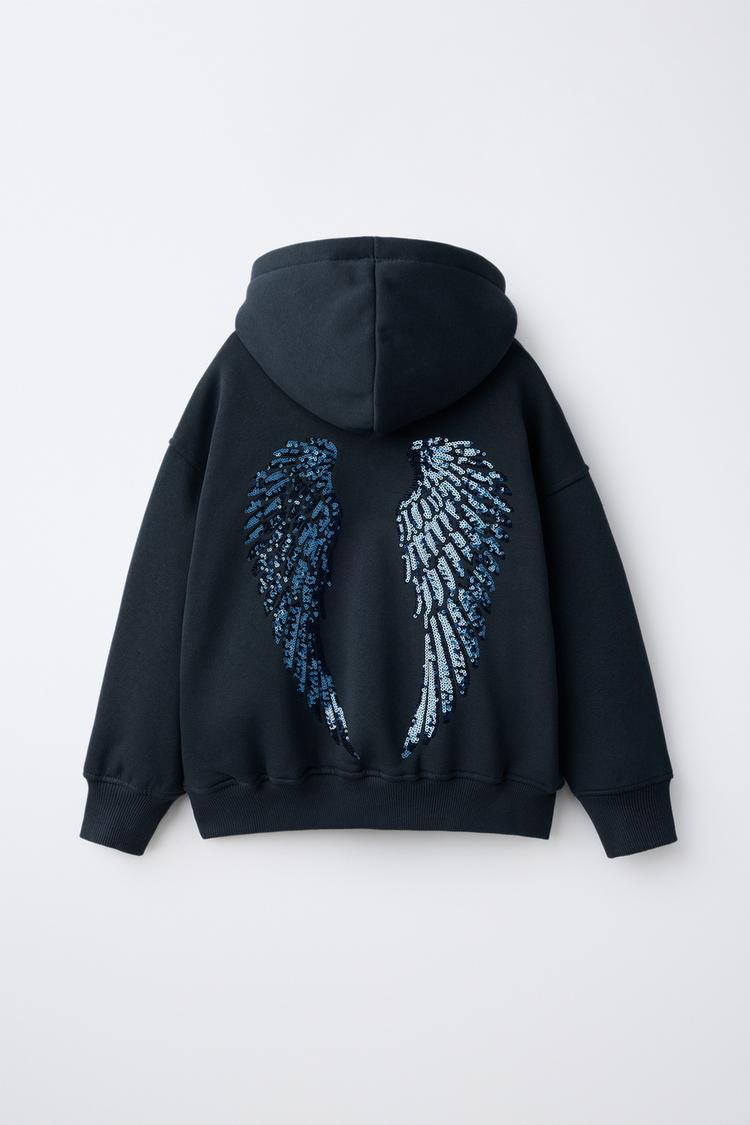 Sudadera capucha alas lentejuelas