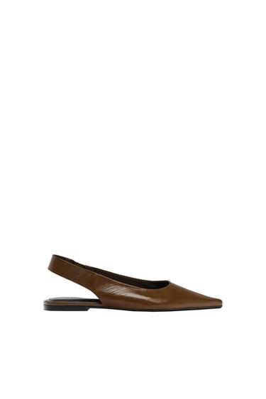 Side view of a brown low-heeled slingback shoe.