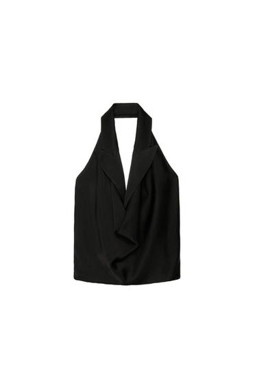 Black sleeveless halter neck top with lapels, on a white background. Elegant and minimalist design.
