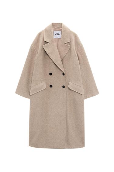 Front view of a beige coat with wide lapels and a double-breasted black closure.