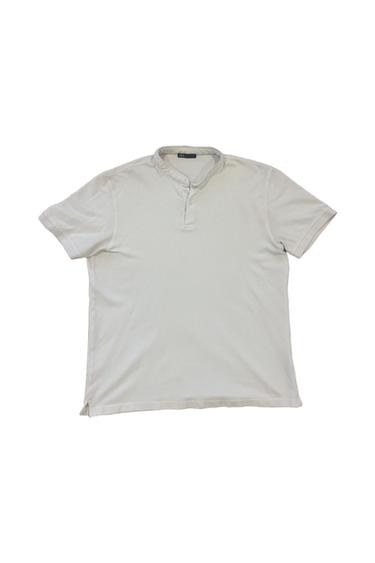 White short-sleeved T-shirt with a henley collar and two buttons, on a white background. Visible label on the collar.