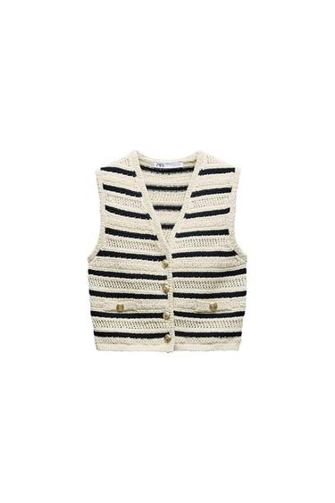 Knitted vest with black and beige stripes and gold buttons. Visible label on the neck with the text "ZARA". White background.