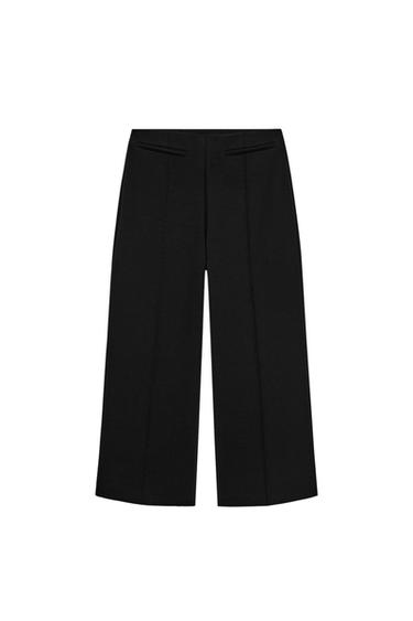 Front view of black wide-leg trousers with faux welt pockets and a concealed zip in the seam.