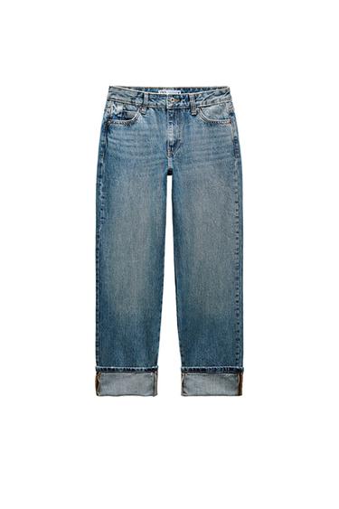 Front view of blue jeans with front pockets and rolled hem.