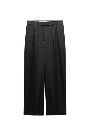 Black dress pants with a relaxed fit, pleats at the front, and a button closure, on a white background.