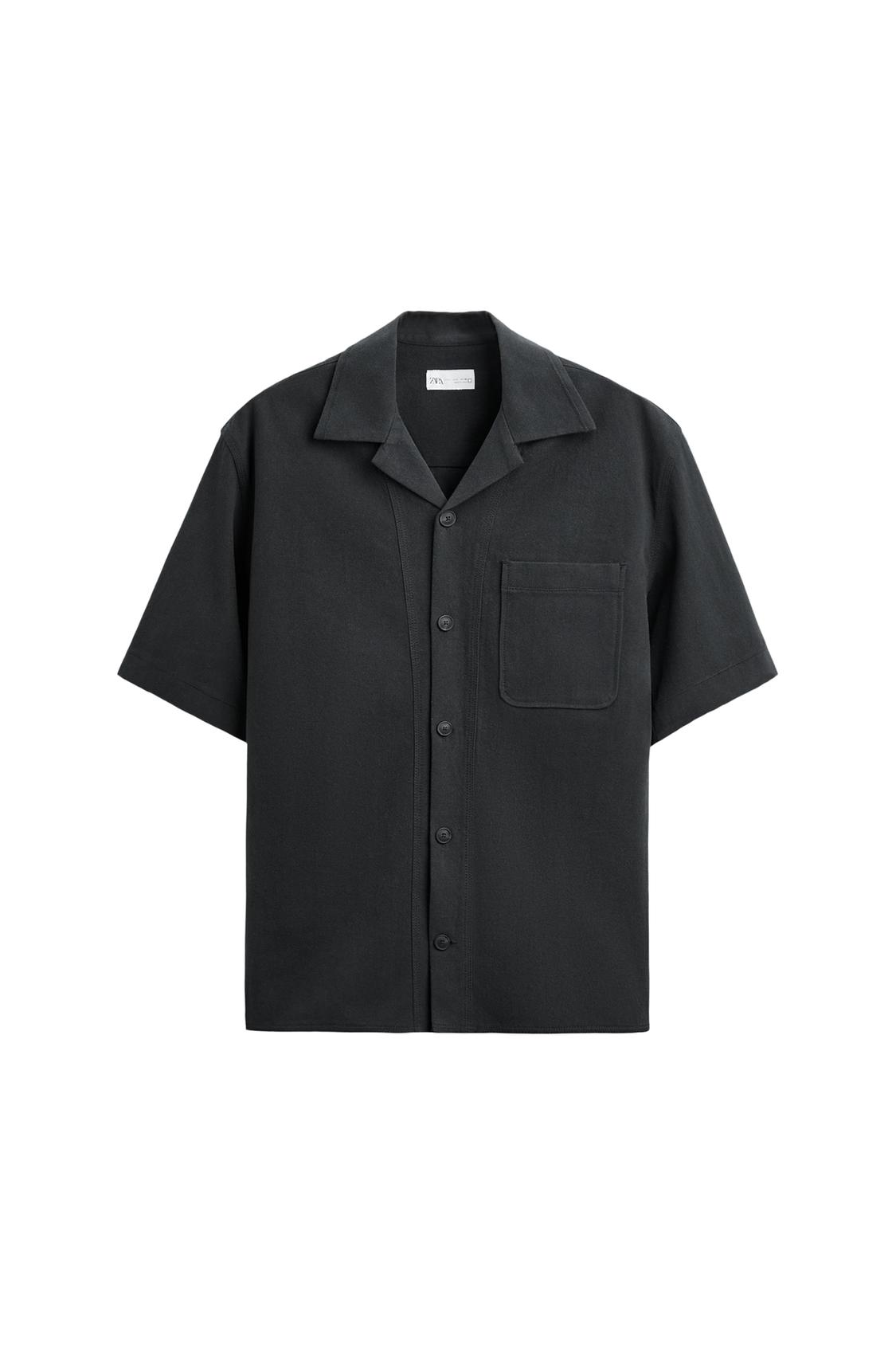 Black short-sleeve shirt with a lapel collar, front button fastening and a chest pocket, on a white background.
