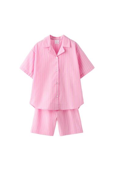 Pink pajama set with white stripes, short-sleeved button-down shirt, and matching shorts, white background.