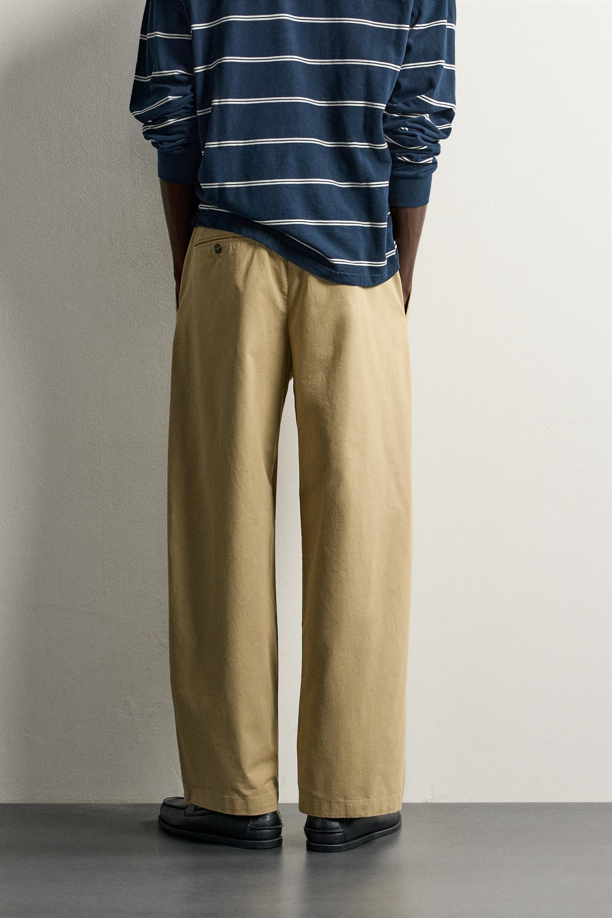 PLEATED CHINO PANTS