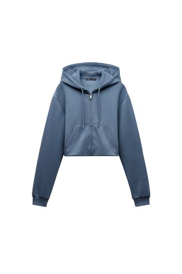 Front view of a blue hooded sweatshirt with a zip and front pockets.