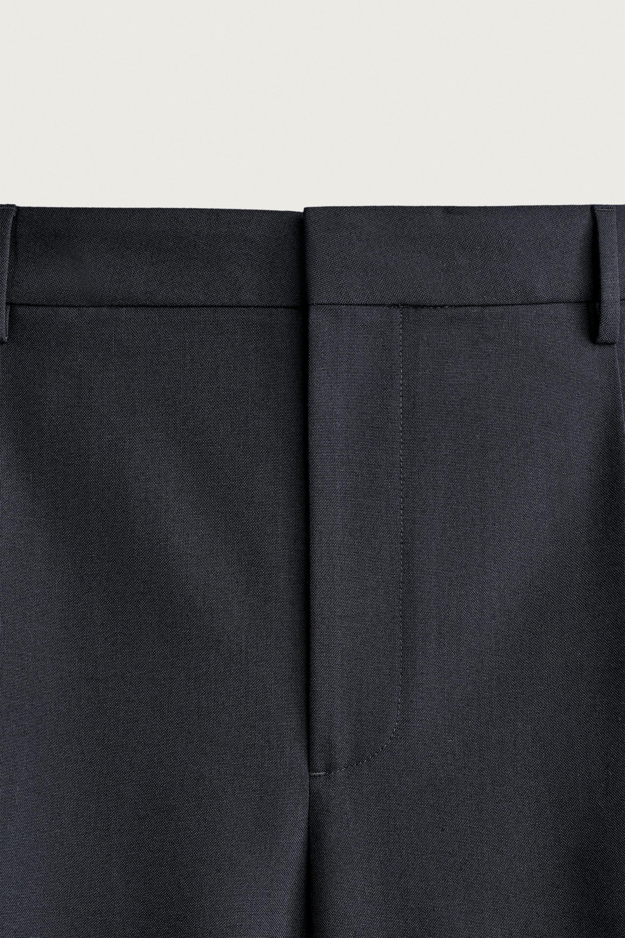 RELAXED FIT PLEATED PANTS