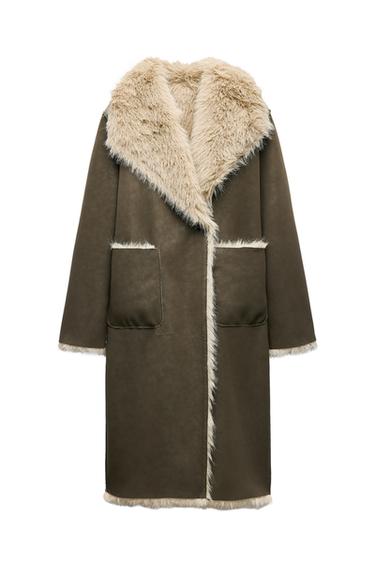 Front view of a long brown overcoat with a beige fur collar and large front pockets.