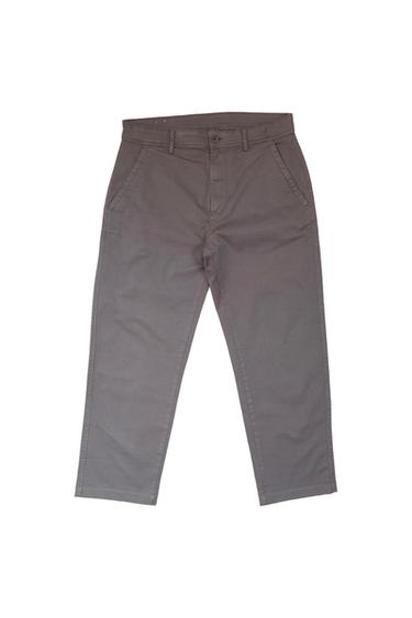Grey casual trousers with side pockets, button fastening at the front and belt loops, on a white background.