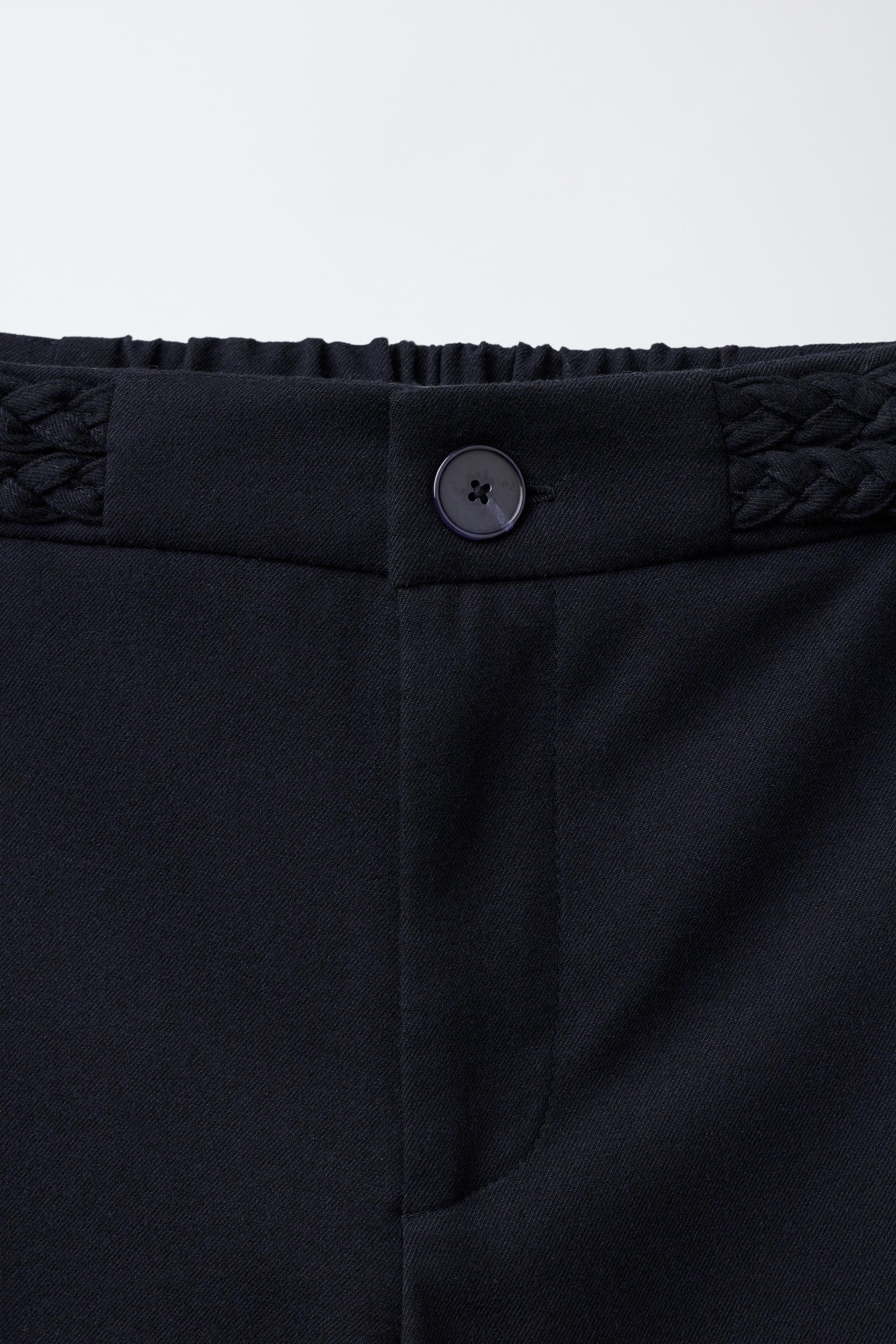 PANTALON À JAMBES LARGES AVEC DÉTAIL TRESSÉ