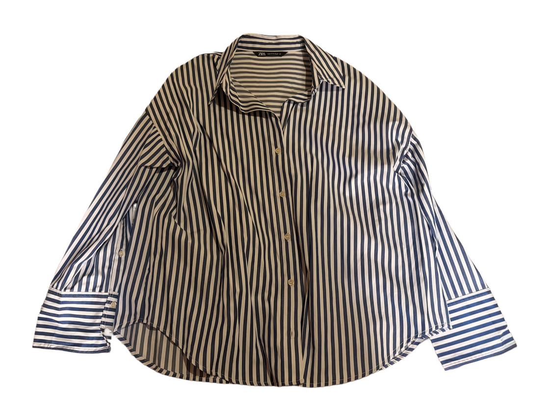 Vertical striped shirt in white and navy, with front buttons and a classic collar, on a white background.