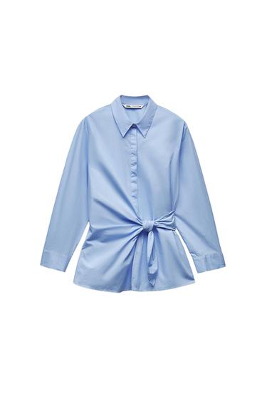 Light blue long-sleeve shirt with a collar and knot detail at the waist on a white background. Label with the text ZARA.