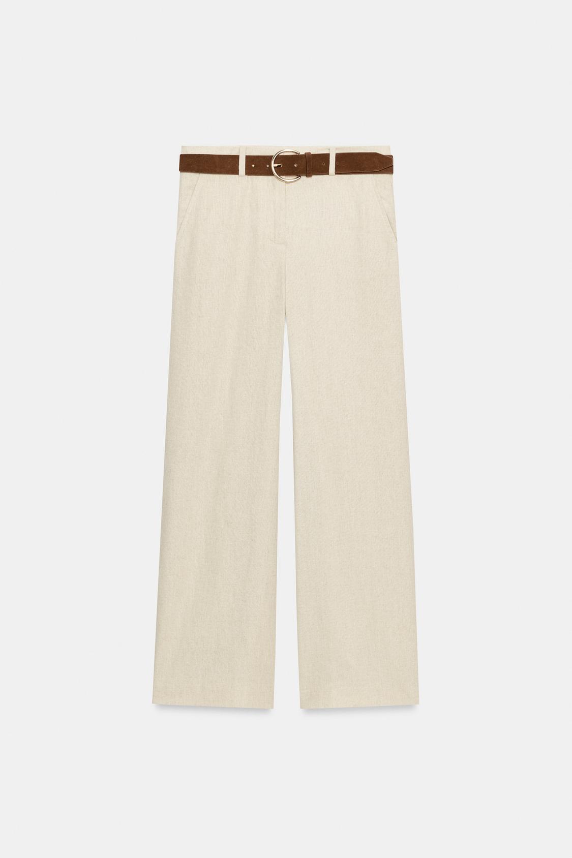Front view of light beige culottes with a brown belt, front pockets, and wide, short legs.