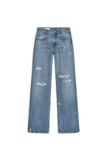 Front view of distressed blue jeans with front pockets and visible rips.