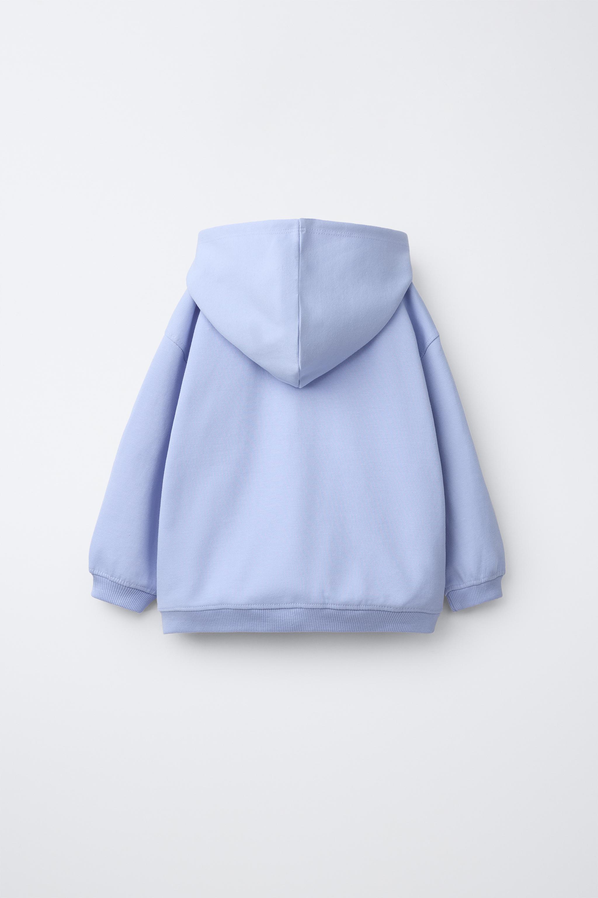 SWEAT ZIPPÉ INTERLOCK AVEC INSCRIPTION EN RELIEF
