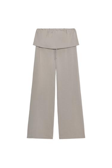 Front view of blue-gray pants with a high elastic waist and a laced sash detail, straight and long leg.