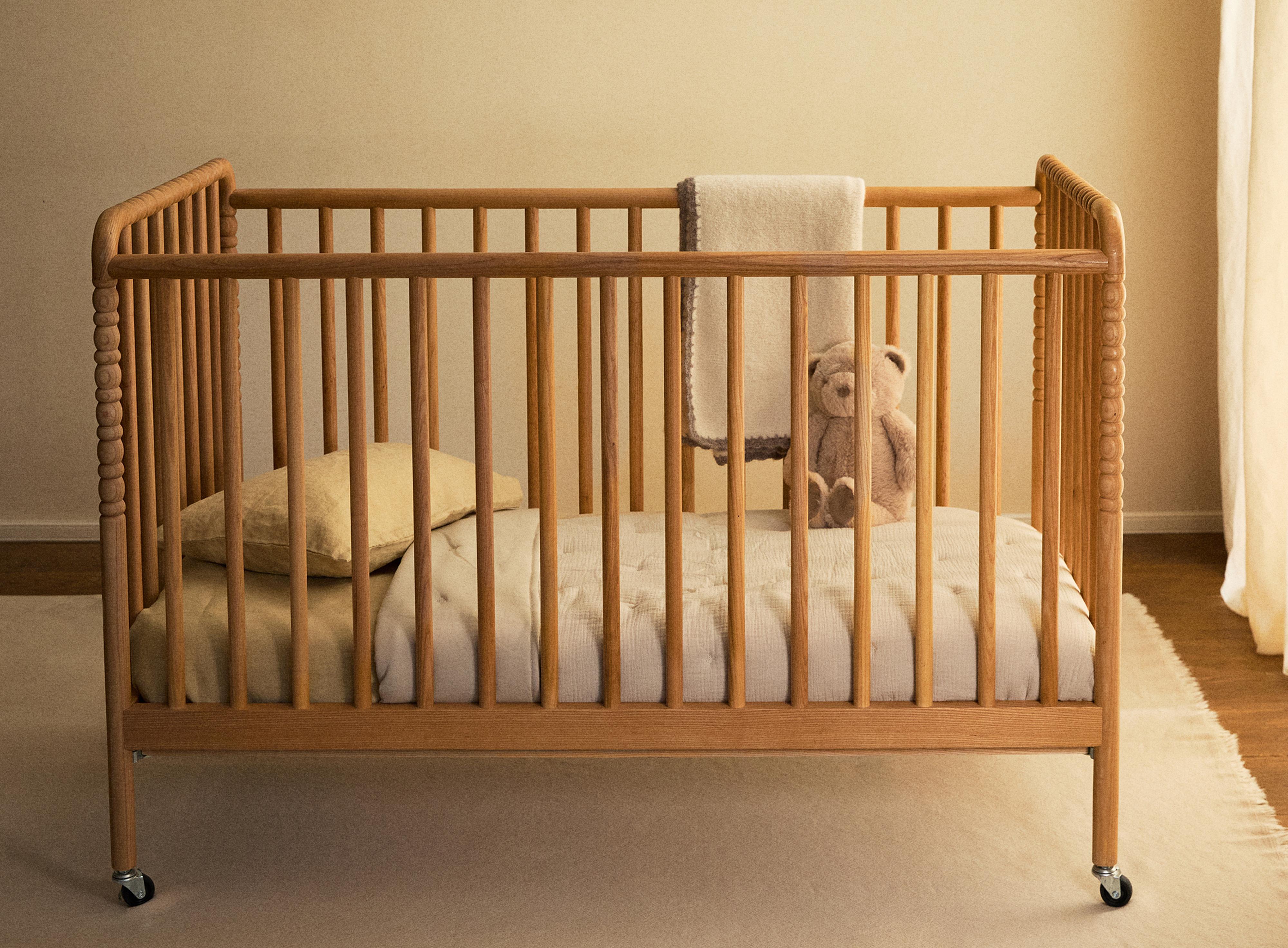 CARVED WOODEN COT WITH WHEELS — Light beige