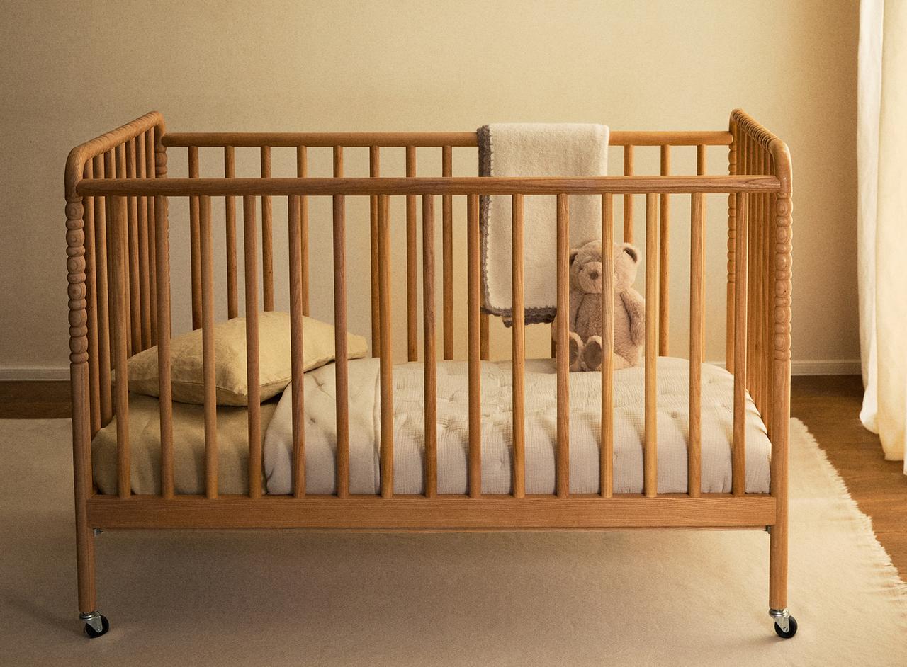 CARVED WOODEN COT WITH WHEELS — Light beige