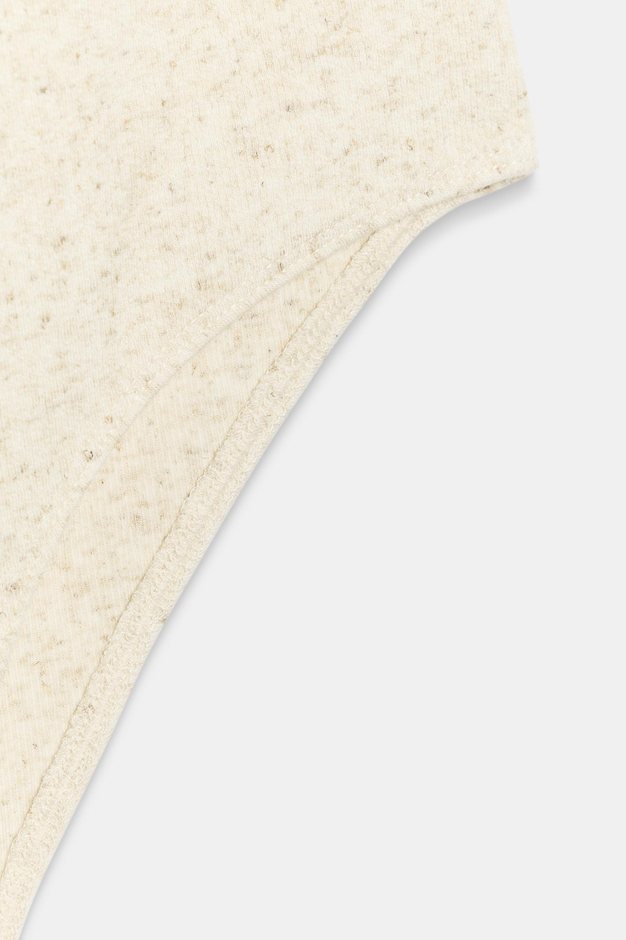 SLEEVELESS BODYSUIT