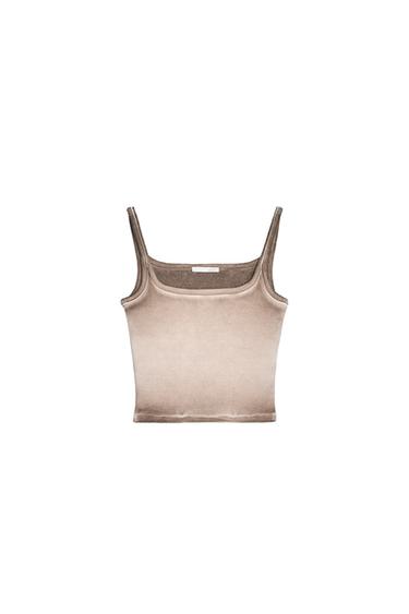 Front view of a beige sleeveless top with spaghetti straps.