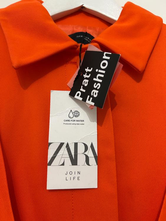 Orange shirt with "Pratt Fashion" and "ZARA JOIN LIFE" labels. Additional text: "CARE FOR WATER Produced using less water".