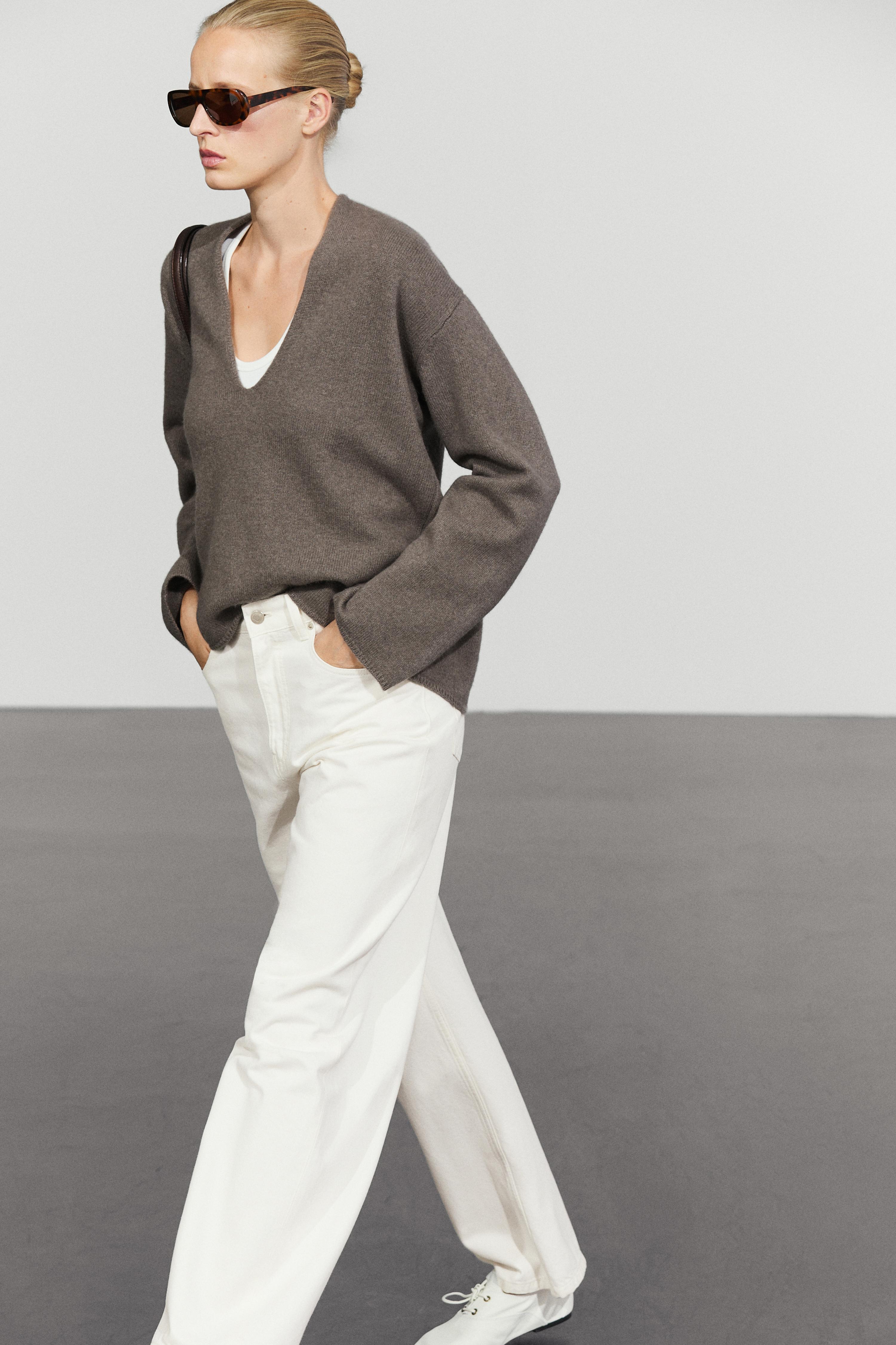 Long-line knit sweater with neckline detail