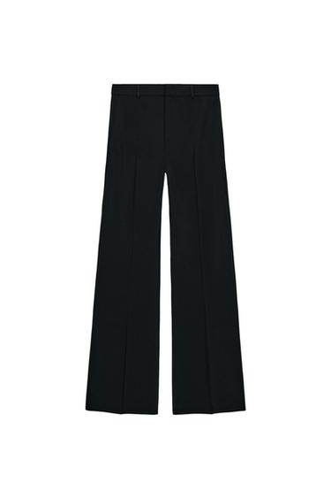 Front view of black, wide-leg, high-waisted pants with front pockets and a front zipper and button closure.