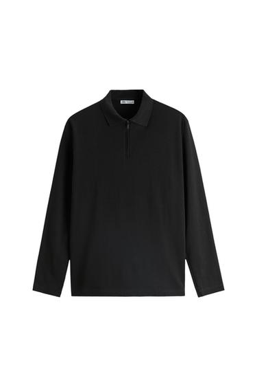 Front view of a black zip-neck polo shirt with long sleeves.