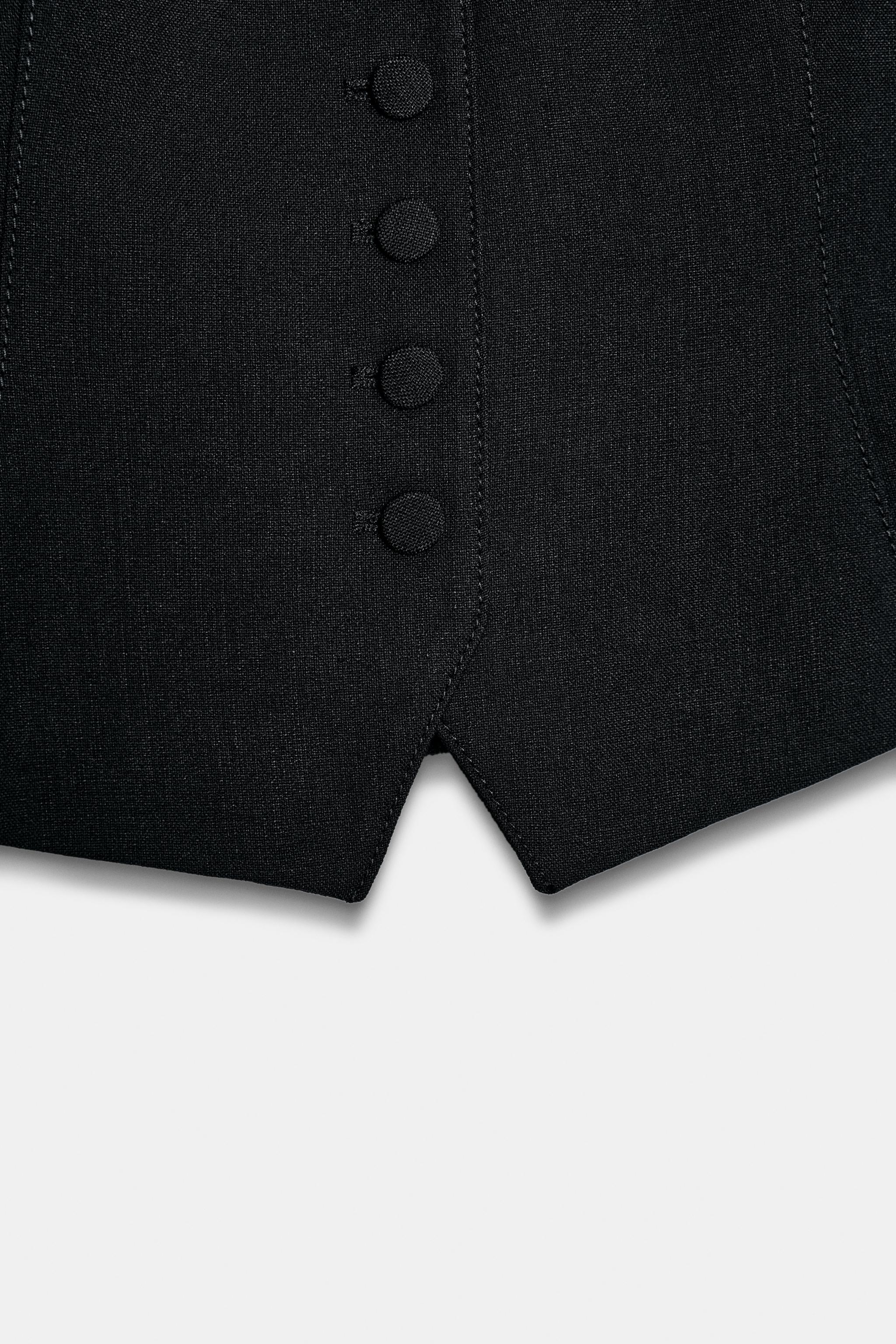 GILET À BOUTON REVÊTU