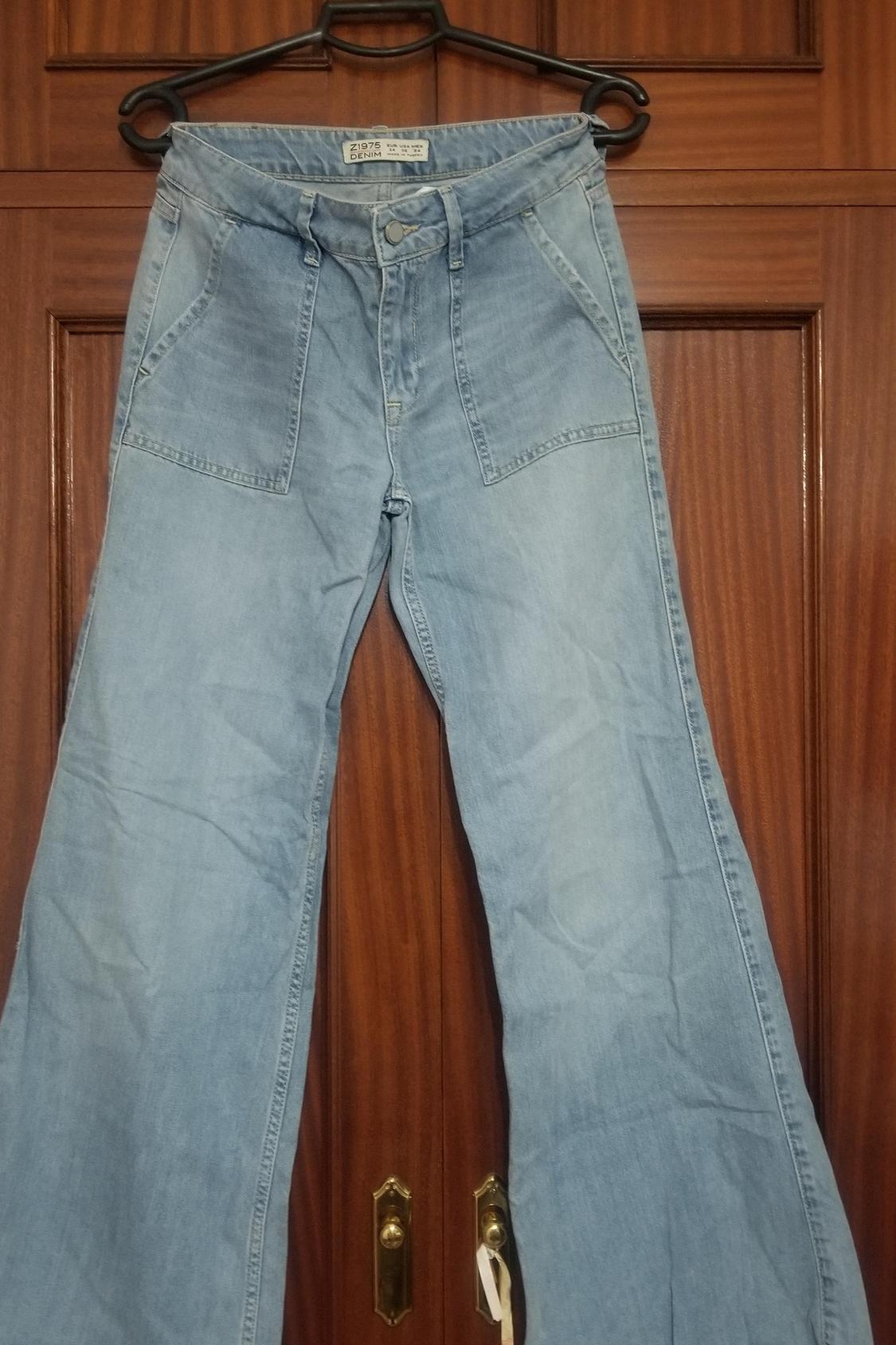 Front view of high-waisted jeans with large front pockets and wide leg