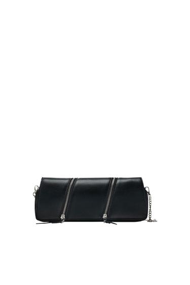 Black rectangular handbag with three diagonal zips and a metal chain on a white background.