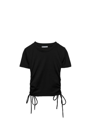 Black short-sleeved, round-neck T-shirt. Side ruching detail with drawstrings at the hem. White background. ZARA label.