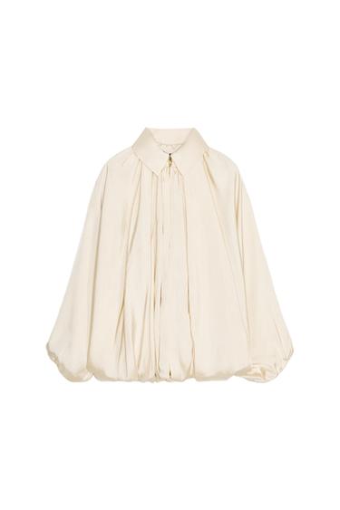 Front view of a beige blouse with a classic collar and puff sleeves.