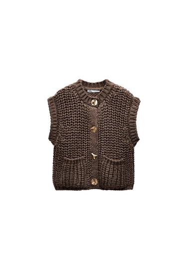 Front view of a brown waistcoat with gold buttons and front pockets.