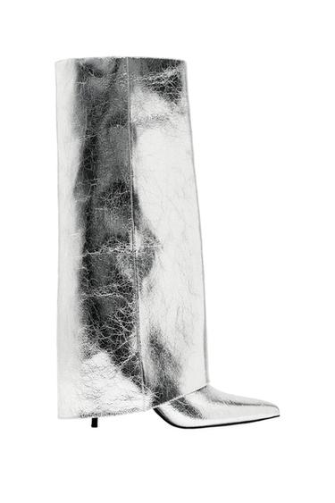 Silver high boot with wrinkled texture, sharp toe, and low heel, on a white background.
