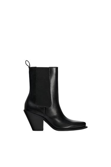 Black pointed-toe ankle boots with a slanted block heel, side elastic panels and a back pull tab on a white background.