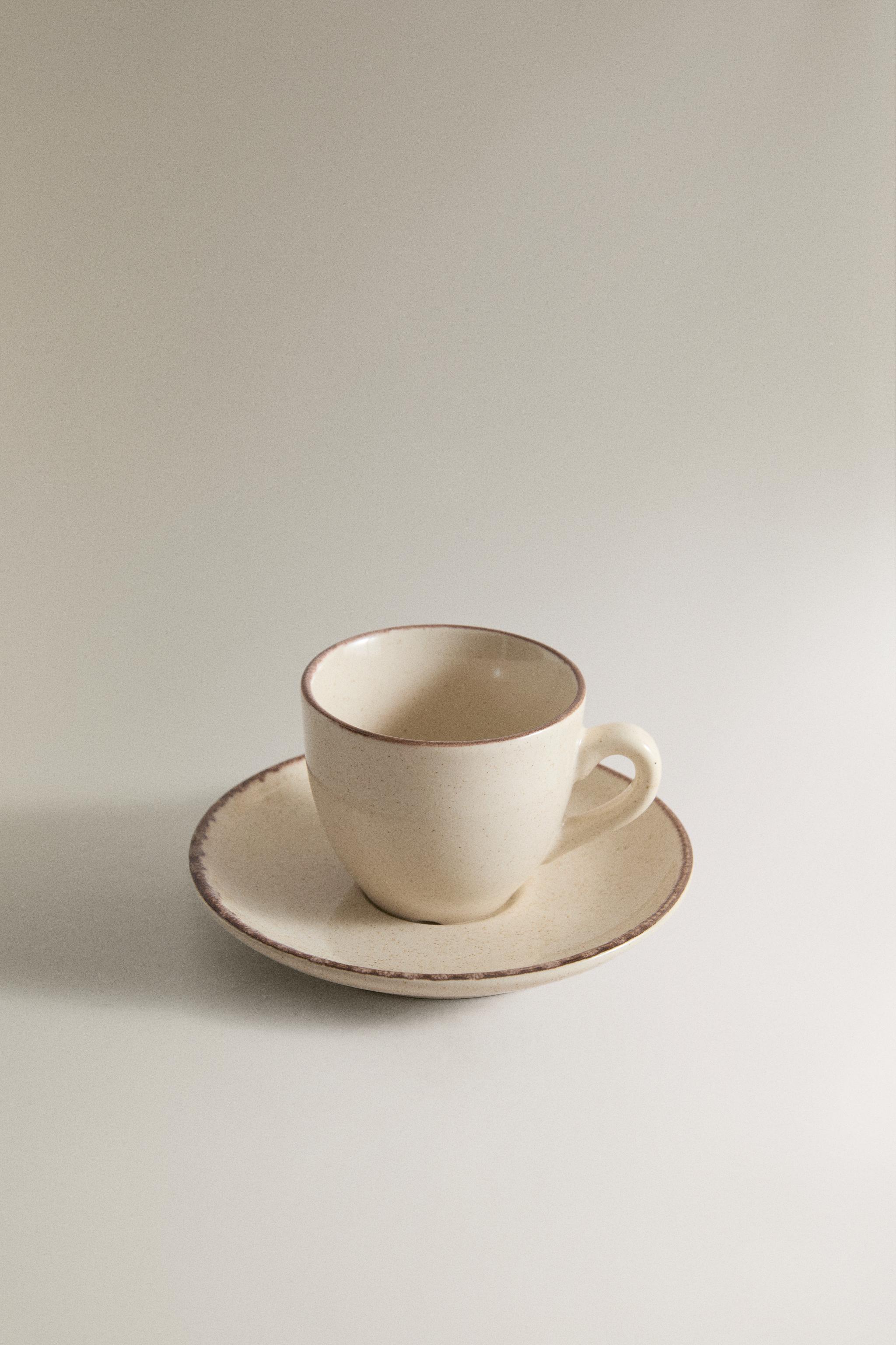 STONEWARE COFFEE CUP AND SAUCER WITH DISTRESSED RIM