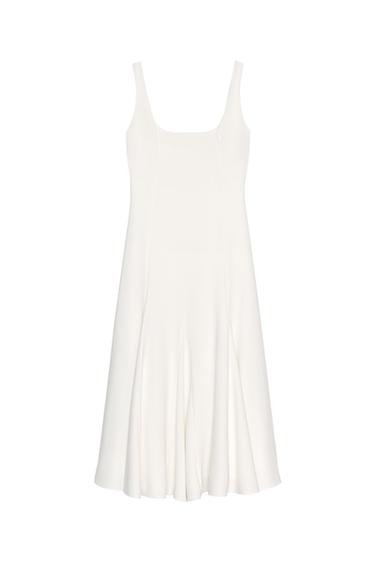 Front view of a sleeveless white dress with a square neckline and a flared skirt.