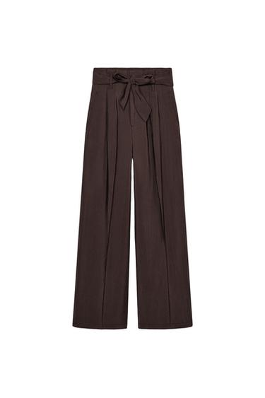 Front view of brown trousers with tie waist and pleats.