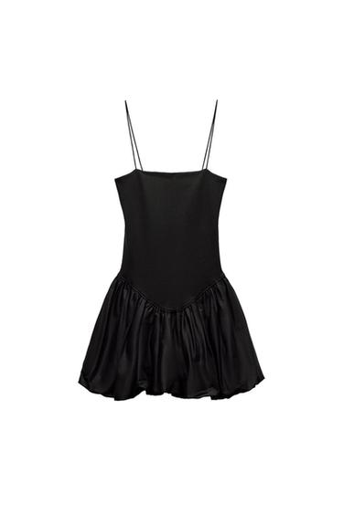 Black short dress with thin straps, fitted bodice with a V-neckline and gathered, voluminous skirt, on a white background.