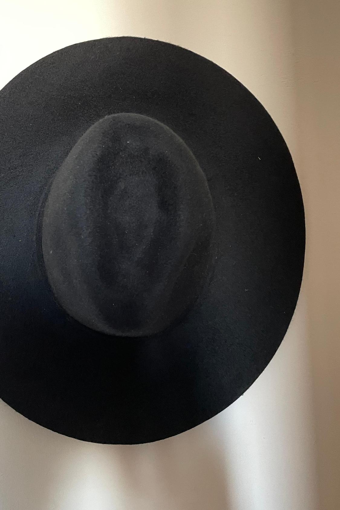 Front view of black wide-brimmed hat.