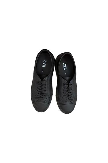 A pair of black lace-up sneakers viewed from above on a white background. Inside, you can read ZARA and size 43.