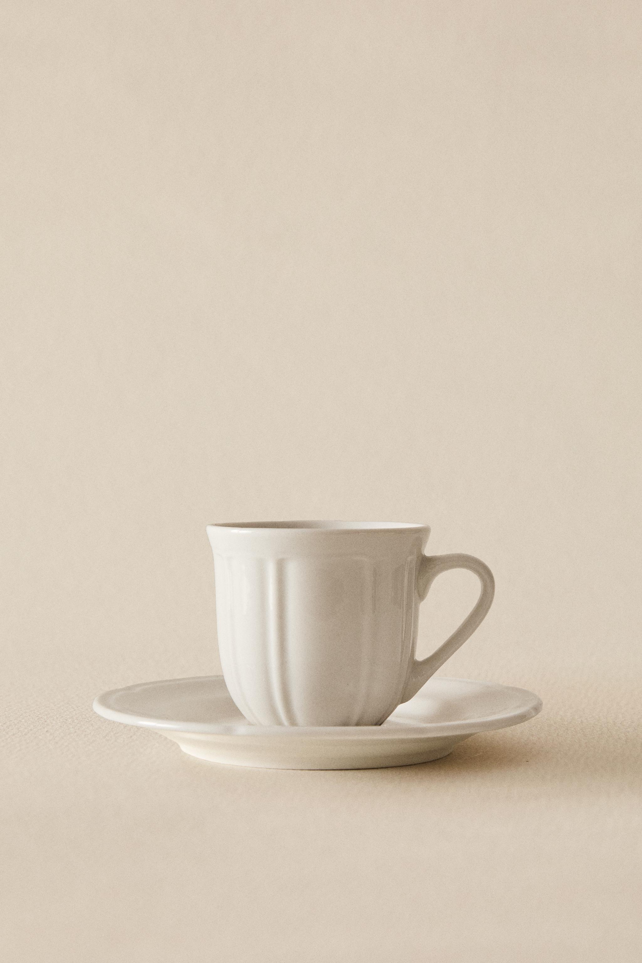 COFFEE CUP AND PORCELAIN SAUCER WITH RAISED DESIGN