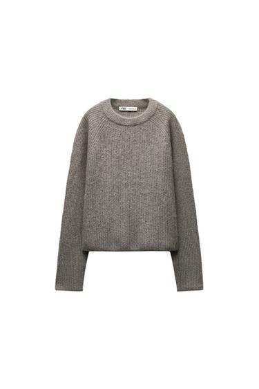 Front view of a grey jumper with a crew neck and long sleeves.