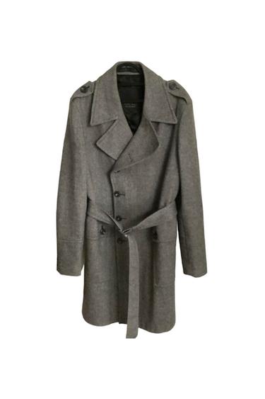 Grey wool coat with a belt and front buttons. Classic design with wide lapels and decorative shoulder pads.